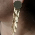 Chain tassel dangler earring in ear